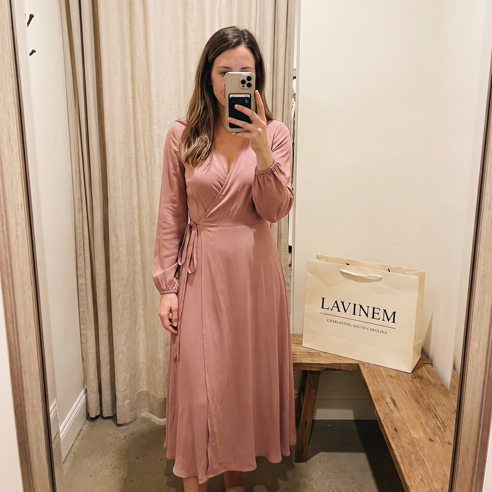 Customer photo: dusty pink wrap midi dress in a fitting room with a Lavinem shopping bag